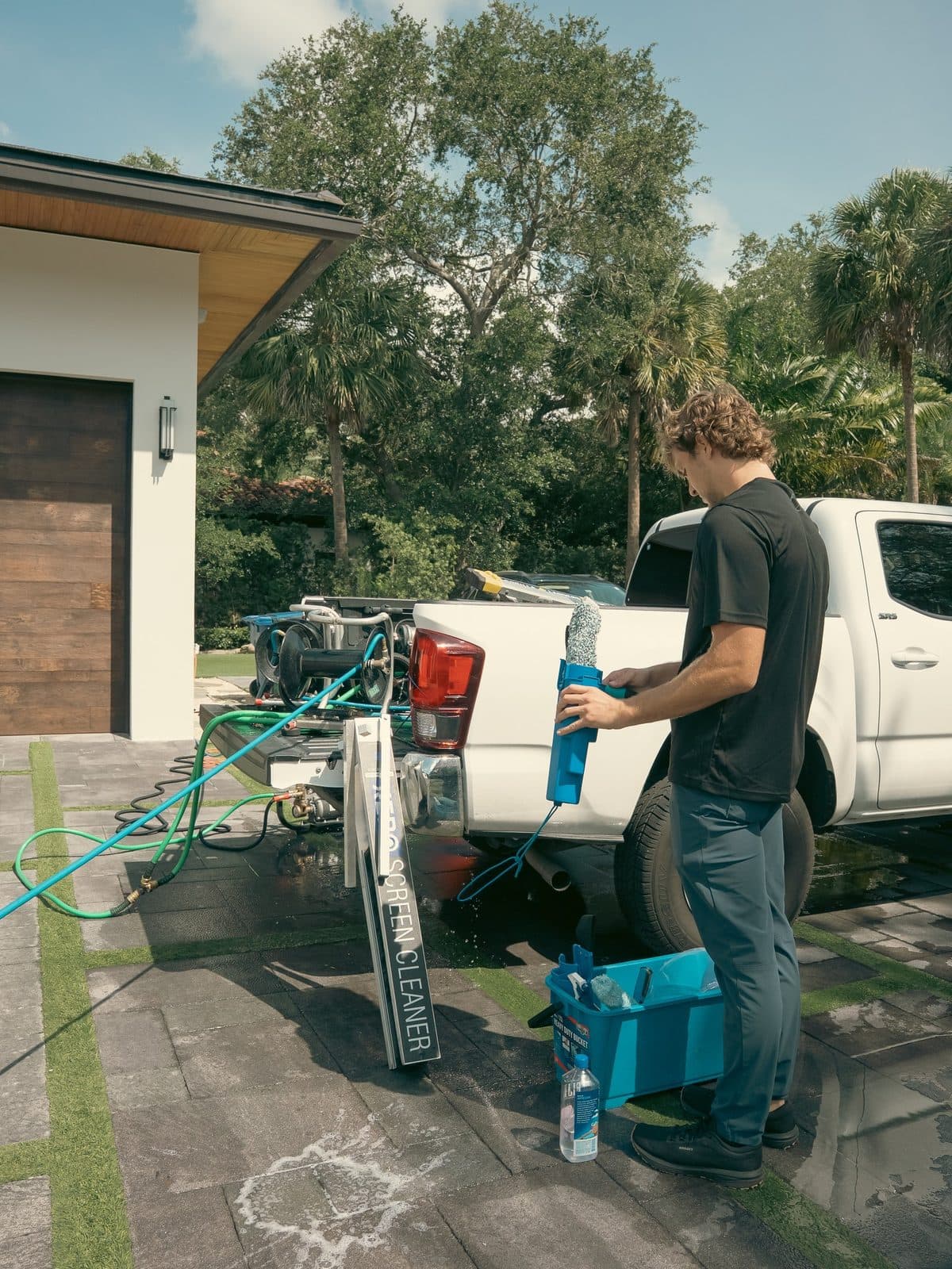 Two Fresh Frames technicians cleaning exterior windows on a Florida home