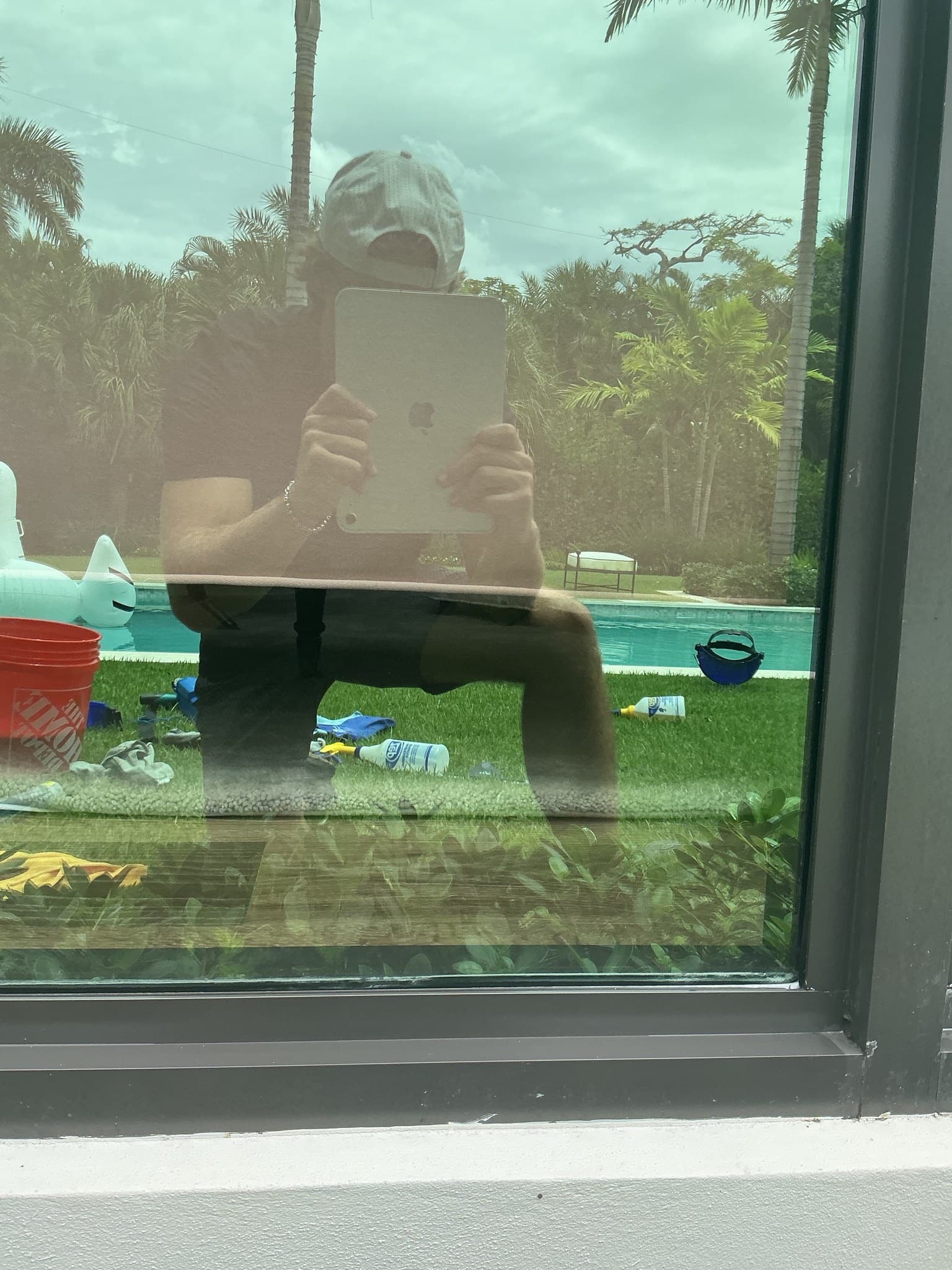 After — the same window restored to crystal-clear, the pool and palms sharp and bright