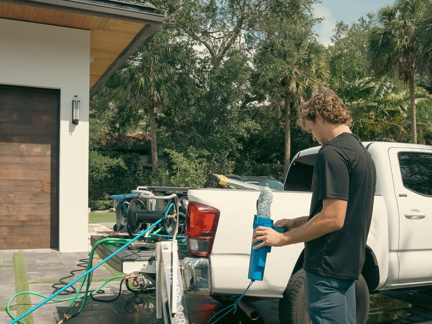 A Fresh Frames crew and work truck on site at a Florida home, ready to clean