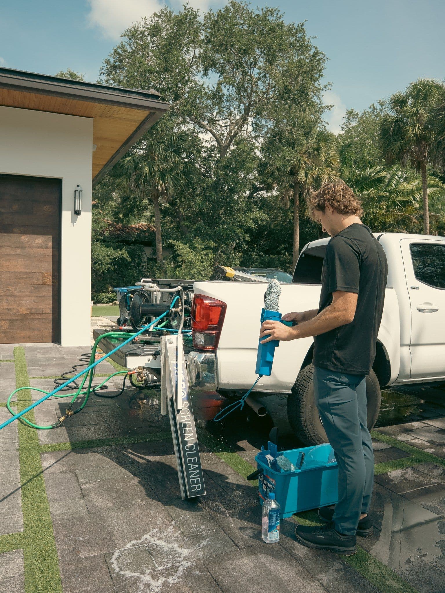 A Fresh Frames crew and work truck on site at a Florida home, prepping for a window cleaning